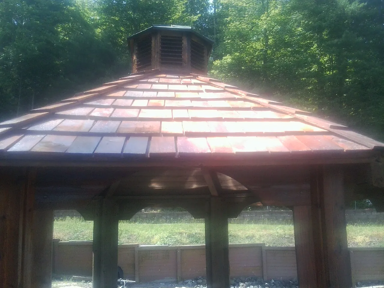 New cedar shake roof and cupola on a lakeside gazebo in Stapleton